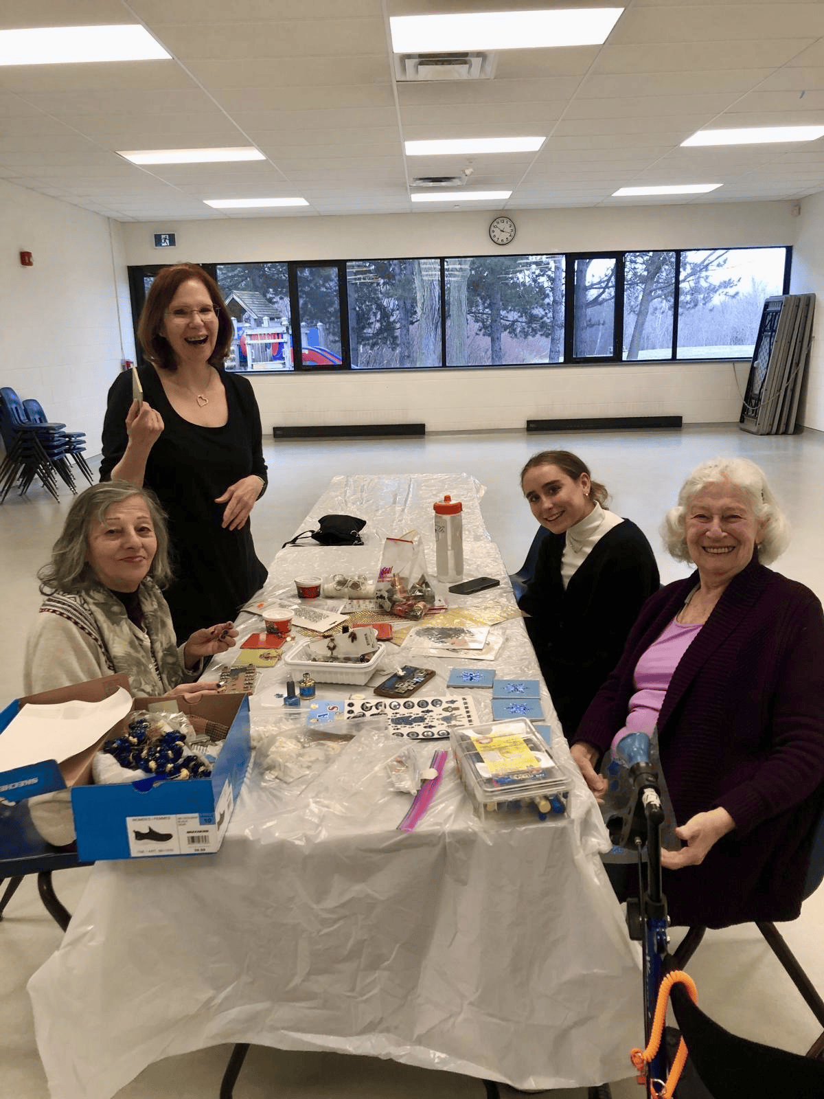 Group of older adults gathered around a craft table