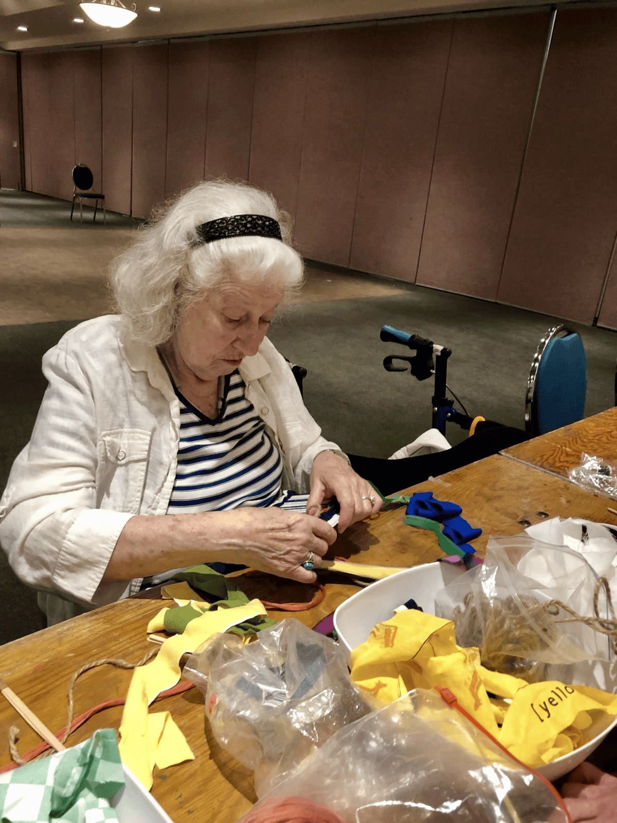 Participant carefully assembling a fabric craft project