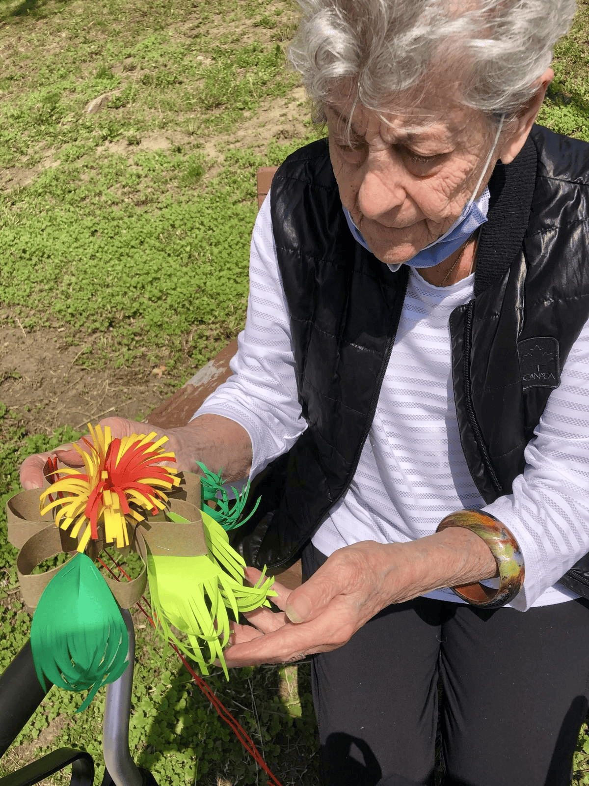 Participant holding a handmade paper flower sculpture